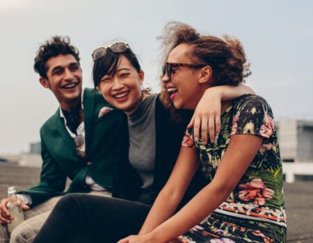 A group of friends laughing and spending time together, illustrating the positive impact of friendships on mental health and connectedness.